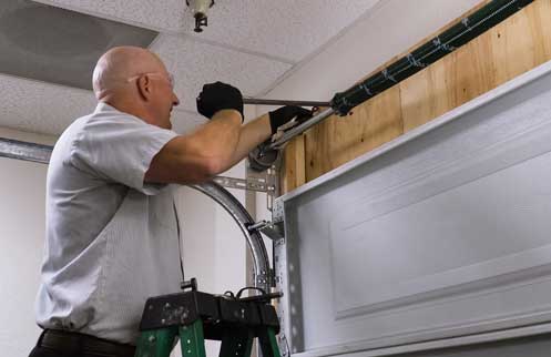 Technician Repairing Garage Door